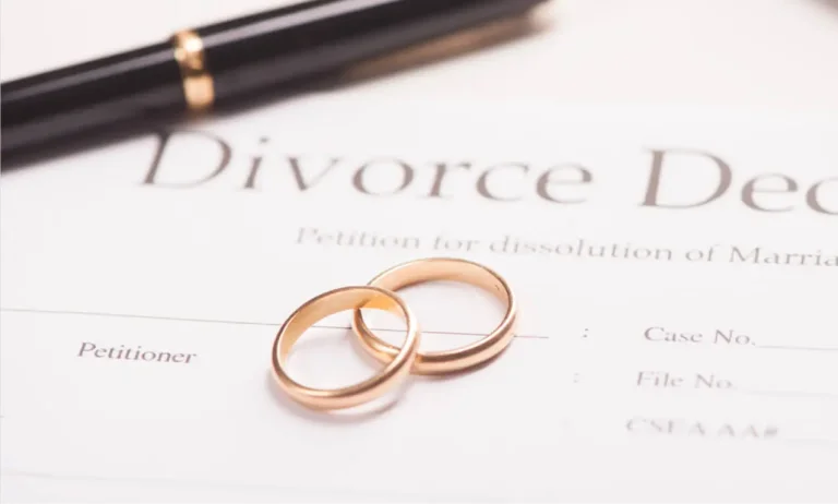 Wedding Rings and pen over divorce papers